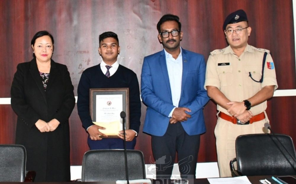 Rahul Roy with 93.33% (aggregate mark) from Rüzhükhrie GHSS, Kohima with officials during the felicitation programme held on June 15. (DIPR Photo)